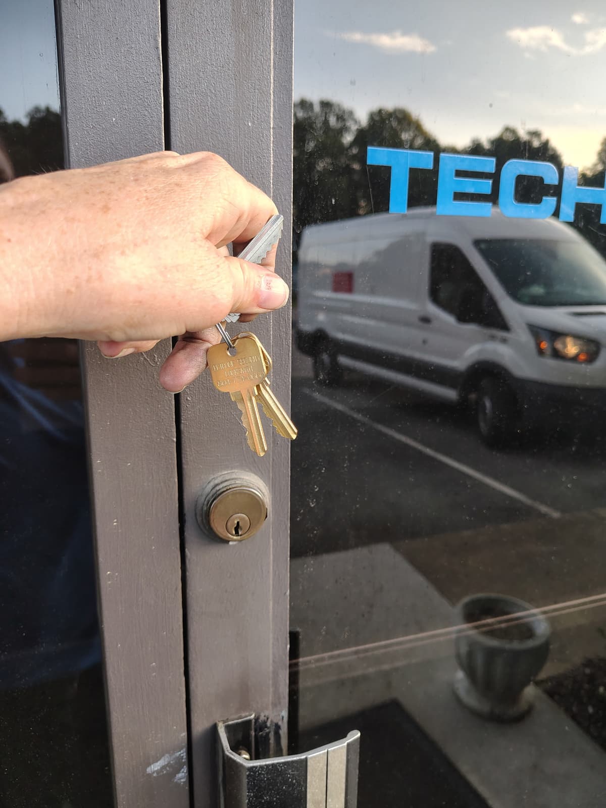 Petrone Locksmith technician demonstrating residential lock service at customer's front door